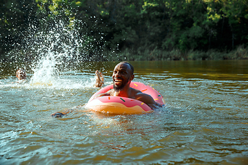 Image showing Happy man having fun, laughting and swimming in river