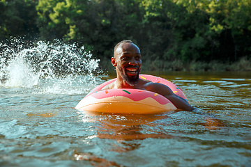 Image showing Happy man having fun, laughting and swimming in river