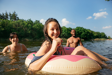 Image showing Happy group of friends having fun, laughting and swimming in river