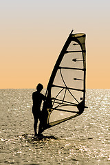 Image showing Silhouette of a windsurfer on waves of a gulf 