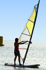 Image showing A women on a windsurf on waves