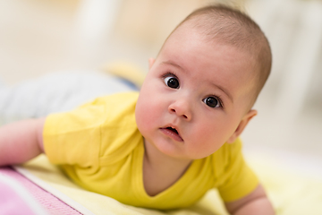 Image showing newborn baby boy playing on the floor