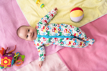 Image showing top view of newborn baby boy lying on colorful blankets