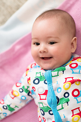 Image showing top view of newborn baby boy lying on colorful blankets