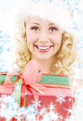 Image showing cheerful santa helper girl with gift box