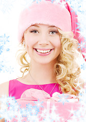 Image showing cheerful santa helper girl with gift box