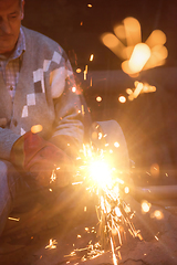 Image showing the blacksmith polishing metal products