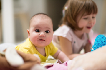 Image showing little sister and her baby brother playing at home