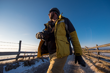 Image showing young photographer walking on country road