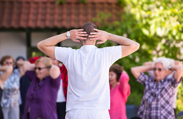 Image showing trainer training motivated active healthy senior people