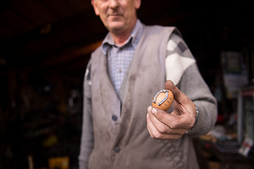 Image showing A blacksmith worker showing handmade products ready for sale