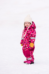 Image showing little girl having fun at snowy winter day