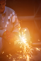 Image showing the blacksmith polishing metal products