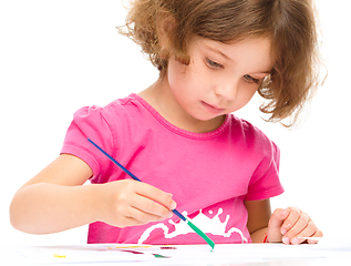 Image showing Little girl is painting with gouache