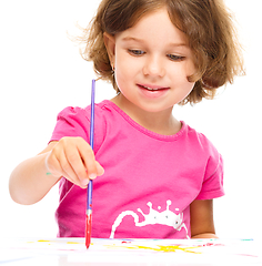 Image showing Little girl is painting with gouache