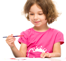 Image showing Little girl is painting with gouache