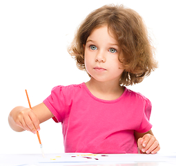 Image showing Little girl is painting with gouache