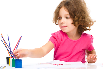 Image showing Little girl is painting with gouache