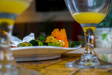 Image showing Closeup of salmon salad and orange juice. 