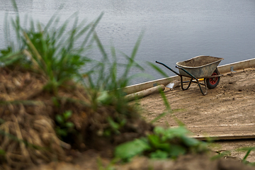 Image showing Wheelbarrow for construction in site building area.