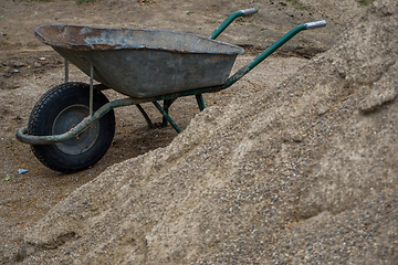 Image showing Wheelbarrow for construction in site building area.