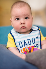 Image showing baby boy sitting between the pillows on sofa