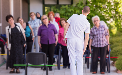 Image showing trainer training motivated active healthy senior people