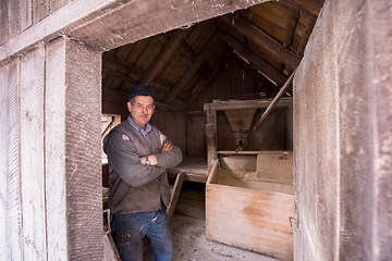 Image showing portrait of a miller in retro wooden watermill