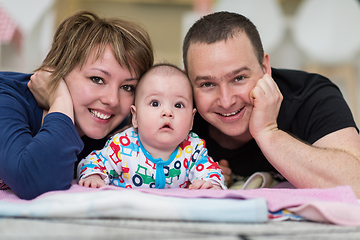 Image showing Portrait of young happy couple with their adorable baby boy