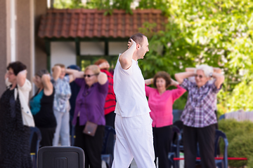 Image showing trainer training motivated active healthy senior people