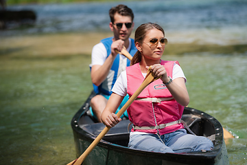 Image showing couple of conoining on wild river