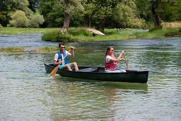 Image showing couple of conoining on wild river