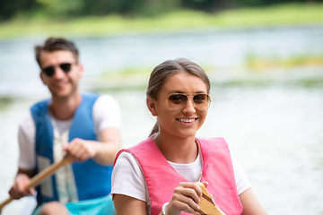 Image showing couple of conoining on wild river