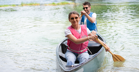 Image showing couple of conoining on wild river