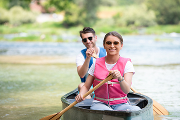 Image showing couple of conoining on wild river