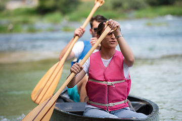 Image showing couple of conoining on wild river