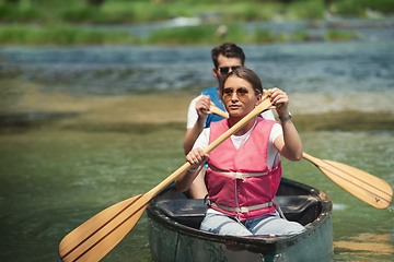 Image showing couple of conoining on wild river