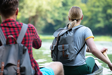 Image showing couple of explorers conoining on wild river