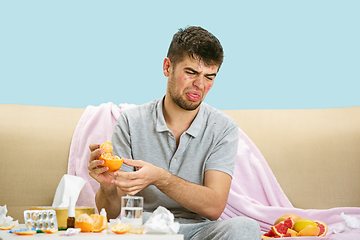 Image showing Young man suffering from allergy to citrus fruits