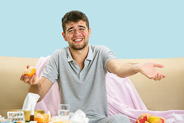 Image showing Young man suffering from allergy to citrus fruits