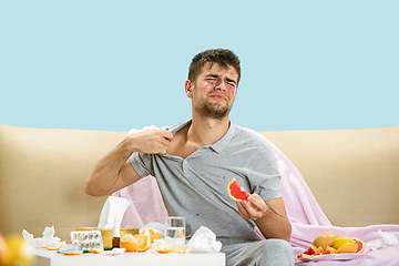 Image showing Young man suffering from allergy to citrus fruits