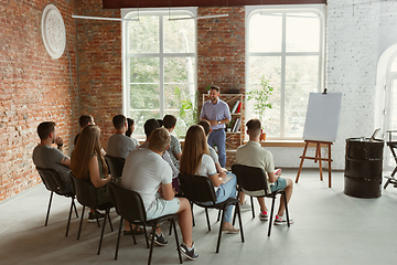 Image showing Male speaker giving presentation in hall at university workshop