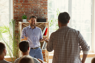 Image showing Male speaker giving presentation in hall at university workshop