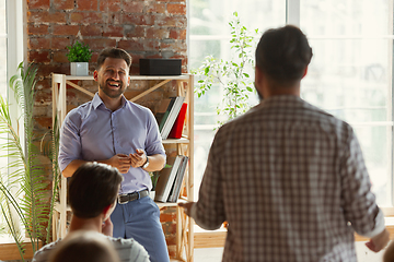 Image showing Male speaker giving presentation in hall at university workshop