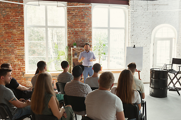 Image showing Male speaker giving presentation in hall at university workshop