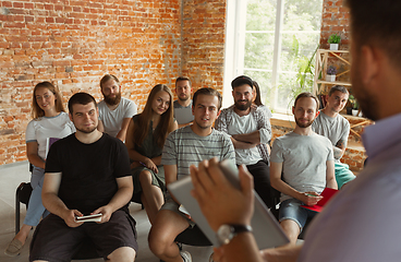 Image showing Male speaker giving presentation in hall at university workshop