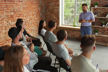 Image showing Male speaker giving presentation in hall at university workshop