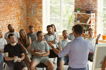 Image showing Male speaker giving presentation in hall at university workshop