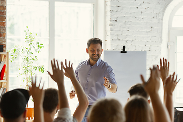 Image showing Male speaker giving presentation in hall at university workshop