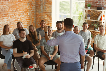 Image showing Male speaker giving presentation in hall at university workshop